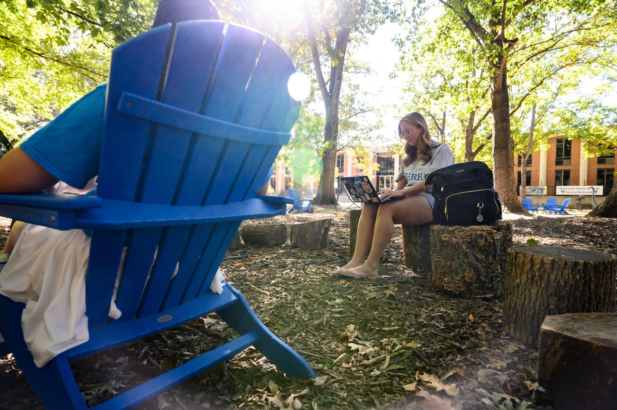 Students sitting outside on campus.